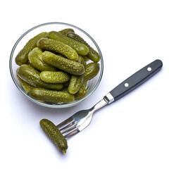 Bowl of Tasty canned Whole green cornichons isolated on a white background