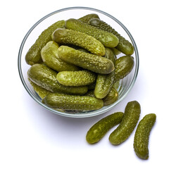 Bowl of Tasty canned Whole green cornichons isolated on a white background