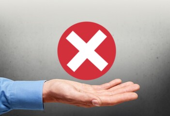 Hand holds icon, cancellation symbol, cancel icon. Cross mark flat red icon.