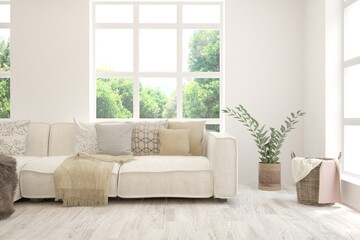 Fototapeta premium White living room with sofa and summer landscape in window. Scandinavian interior design. 3D illustration