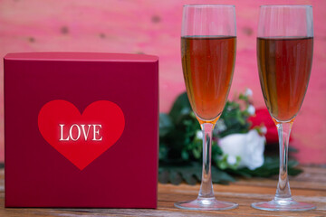 gift box with hearts, glasses of champagne and roses. happy Valentines Day