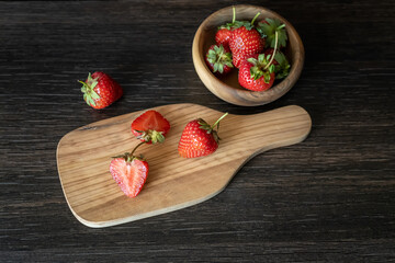 Fototapeta na wymiar Still life with fresh strawberries on a dark background