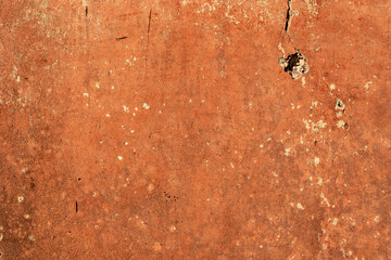 Dark orange painted wall, rough and weathered background texture