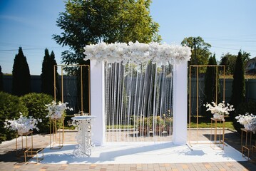 wonderful wedding ceremony. trendy wedding arch made according to modern fashion. wedding decorations.