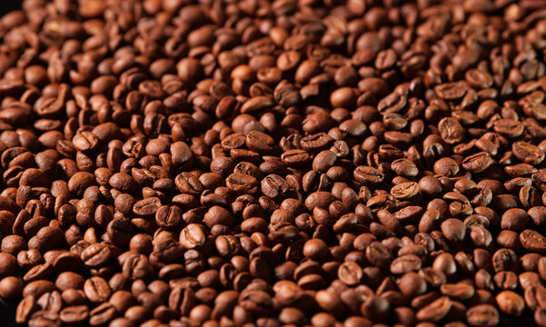 Roasted coffee beans texture. Close up view with a lot of coffee, image that can be used as background.