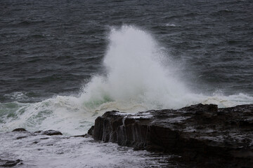 Wave breaking on the rocky coastline.