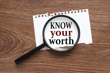 Know Your Worth. Wooden small cubes with letters isolated on blue background with copy space...