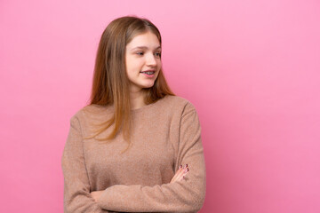 Fototapeta premium Teenager Russian girl isolated on pink background looking to the side
