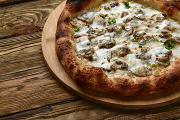 Appetizing pizza with mushrooms on a wooden tray