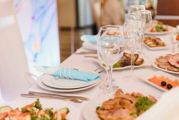 beautifully laid tables with glasses and appliances at morning in restaurant