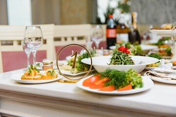 beautifully laid tables with glasses and appliances at morning in restaurant