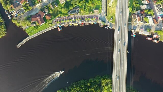 Panning wide view of peaceful darm river at coastal city of Itanhaem Sao Paulo Brazil. South coast of state of Sao Paulo. Tropical scenery for travel destinations and vacation travel.