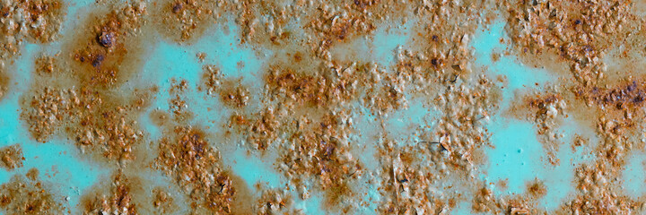 Texture of rusty metal with peeling paint. Rough metal surface with rust. Corroded and oxidized old iron. Rusted and aged metal sheet. Wide panoramic texture for background and design in grunge style.