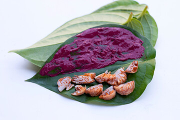 Chewing betel nut, Betel nut with red cal lime powder on betel leaves