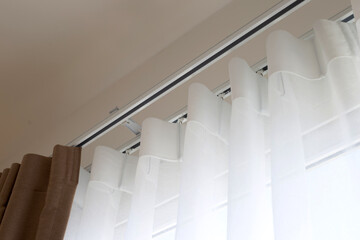 Obraz premium Curtains door or window, Curtain rail with white and brown curtain