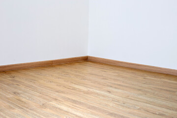 Laminate wood floor with blank white wall