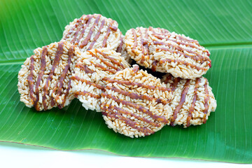 Rice cracker with coconut palm sugar on banana leaf