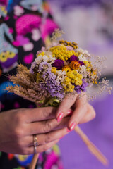 Fototapeta premium bouquet of flowers in hands