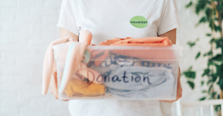 Girl holding plastic container with the inscription donation in her hands.