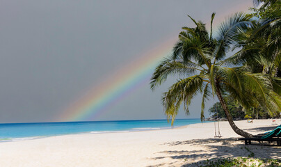 Calm sea before storm with amazing rainbow after the rain -sand beach background