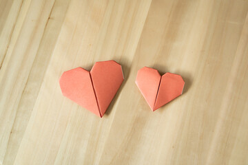 Obraz na płótnie Canvas Origami heart on wooden table