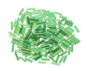 Pile of green bugle beads on white background, top view