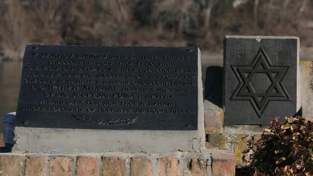 Weathered Metal Plaque Mounted on a Rough Stone Wall