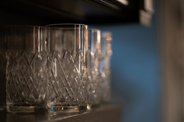 Photo of glass glasses for drinks on blur background. Dishes concept