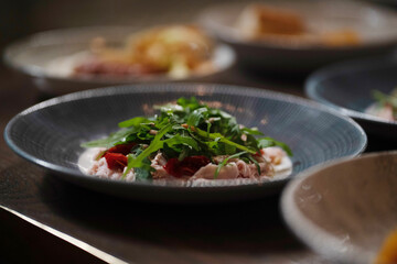 Photo of salad in a plate on a table in a restaurant. Food concept