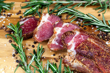 dried and spiced meat sliced on a wooden board