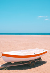 Old wooden boat and beach view. Stylish summer aesthetic wallpaper