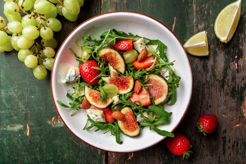 Healthy food. salad with figs, strawberries, grapes, blue cheese dorblu, banner, menu, recipe place for text, top view