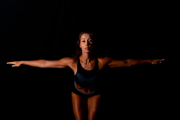 Fototapeta premium Fitness female woman with muscular body, do her workout. Attractive sexy fitness woman, trained female body, lifestyle portrait, caucasian model.