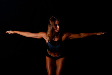 Fototapeta premium Fitness female woman with muscular body, do her workout. Attractive sexy fitness woman, trained female body, lifestyle portrait, caucasian model.