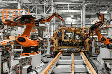 Photo of automobile production line. Welding car body. Modern car assembly plant. Auto industry