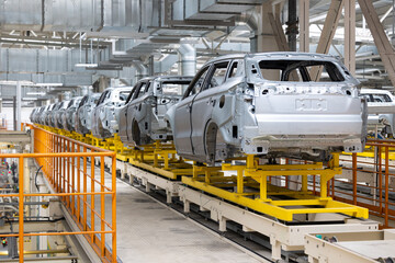 Photo of automobile production line. Welding car body. Modern car assembly plant. Auto industry. High-tech factory