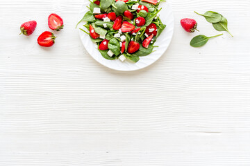 Naklejka na ściany i meble Vegetarian diet - green spinach salad with strawberry and goat cheese