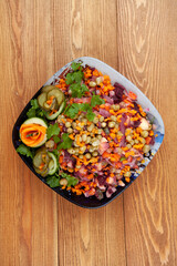 Salad vinaigrette. Traditional Russian salad of vegetables, beets, cucumbers, carrots. beautifully decorated. for a festive table. in a plate. food. on a wooden background. close-up. top view.