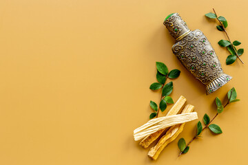 Agar wood tree oil perfume in silver bottle with sticks of tree