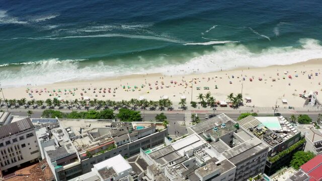 Aerial view Rio de Janeiro Brazil. Beautiful view of the beach in the city with high-rise buildings, the life of a sandy beach which is washed by the ocean waves.