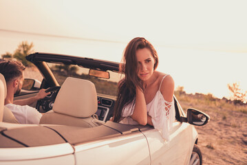 Photo of pretty adorable young husband wife dressed casual outfits riding cabriolet enjoying sunny...