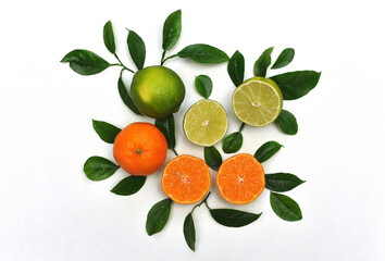 Fresh mandarins and limes with leaves full and  slices on white background with free space  for...