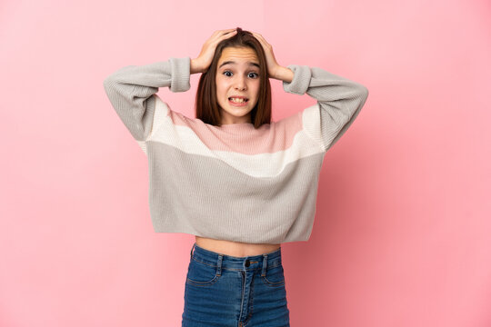 Little girl isolated on pink background doing nervous gesture