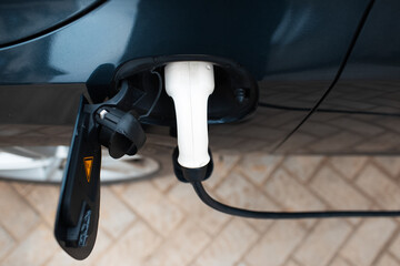 Top view of power cable charging an electric car.