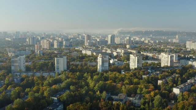 Panorama of Kharkiv in autumn: city buildings among the trees in a misty haze in the morning: establishing shot.
