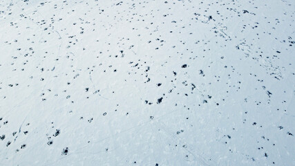 Aerial view of the snowy texture of a frozen lake in winter. North Pole and ice