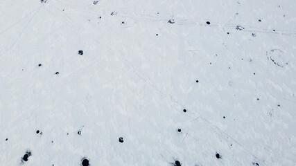 Aerial view of the snowy texture of a frozen lake in winter. North Pole and ice