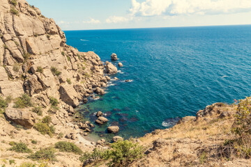 Seascape from the top of the mountains. The nature of the sea. Clouds, sea, mountains. A sunny day. Horizontal photo. Vacation, travel. Concept: calendar, cover.