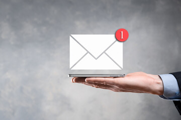 Businessman hand holding e-mail icon, Contact us by newsletter email and protect your personal...