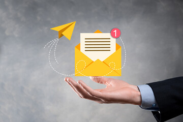 Businessman hand holding e-mail icon, Contact us by newsletter email and protect your personal...